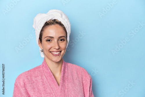 Caucasian woman in pink robe post-shower freshness