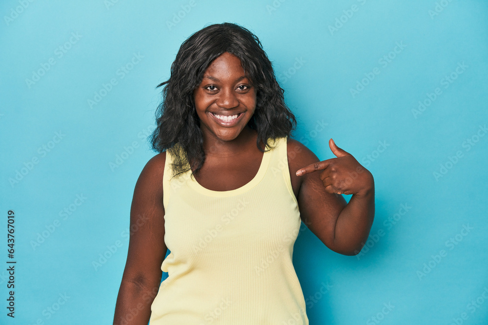 Young african american curvy woman person pointing by hand to a shirt copy space, proud and confident Young african american curvy woman person pointing by hand to a shirt copy space, proud and confident