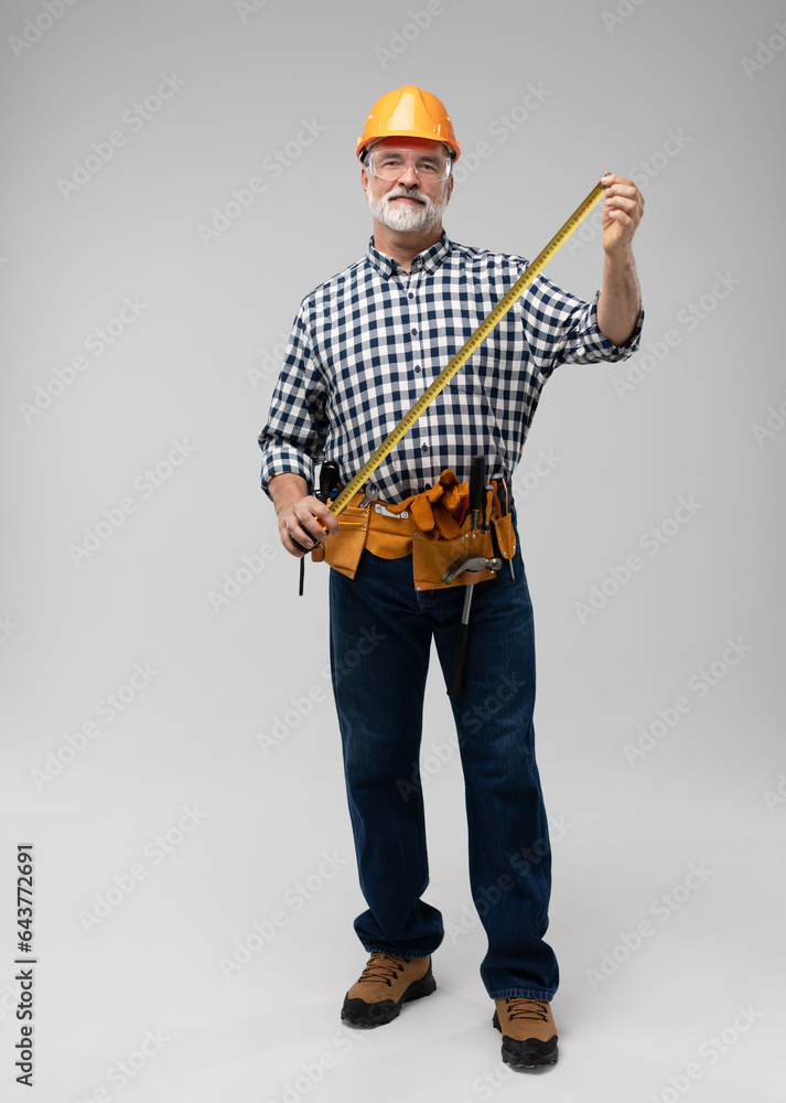 full lenght of mature happy handyman isolated on white background. full lenght of mature happy handyman isolated on white background.