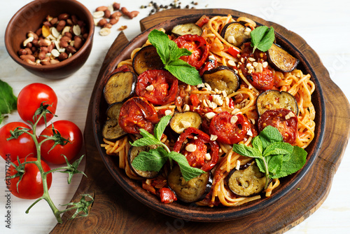 Vegetarian pasta with eggplant and tomatoes in vegetable sauce. Delicious healthy food
