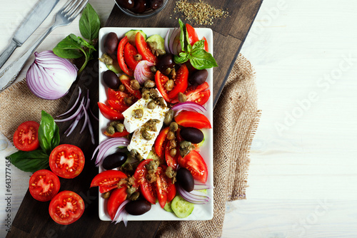 Classic Greek salad of tomatoes, olives, red onions, cucumbers and capers