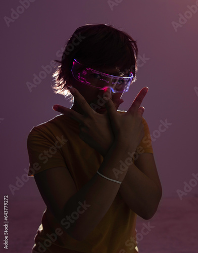 Woman in the dark with luminous glasses photo