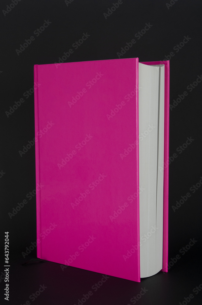 Book with red hardcover close up on black background Book with red hardcover close up on black background