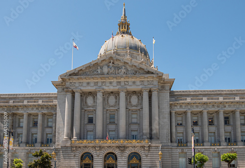 Photography San Francisco, CA, USA - July 12, 2023: Gray stone City Hall east facade pediment above entrance with giant dome under blue sky