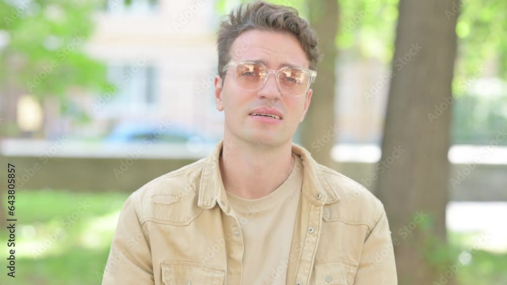 Outdoor Portrait of Tired Casual Young Man with Migraine Outdoor Portrait of Tired Casual Young Man with Migraine