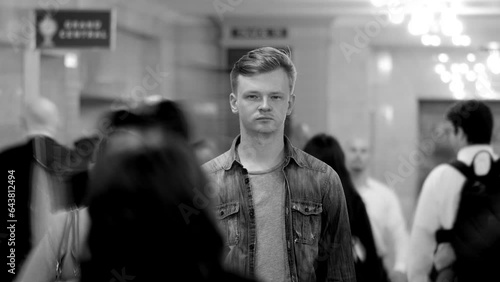 Man Standing Out Of The Crowd People Walking on Crowded Street