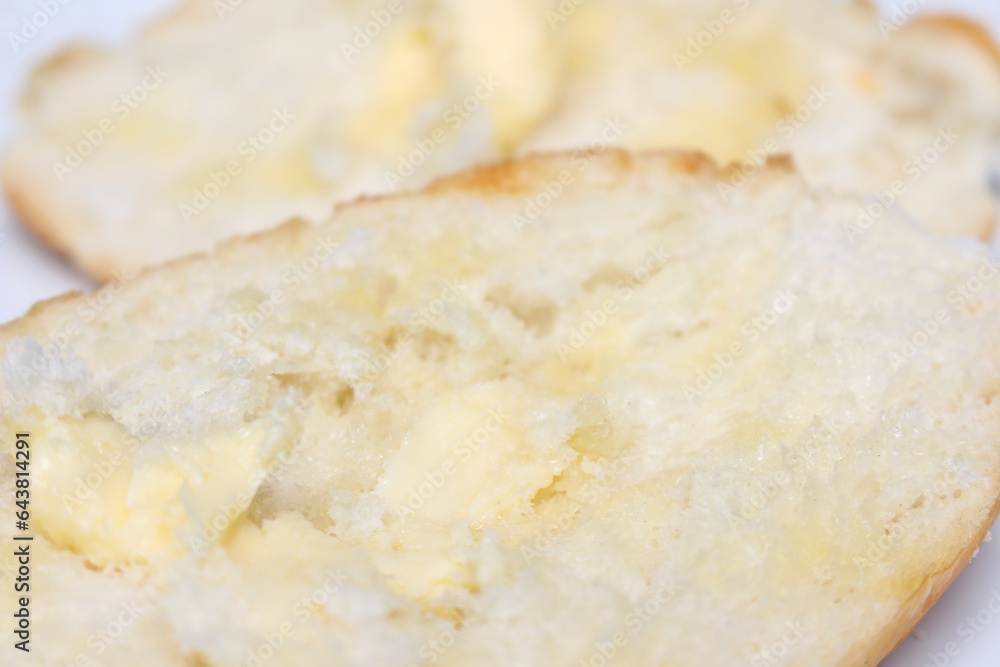 close up of a bread with butter. bread and butter with selective focus. sliced ​​bread with butter.