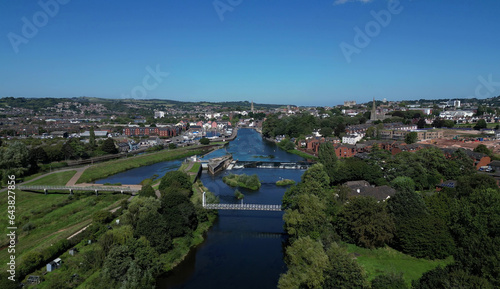 Exeter, South Devon, England: DRONE VIEWS: The River Exe (centre); Exeter Ship Canal (left); Trews Weir and Suspension Bridge; Exeter Quays and the city of Exeter skyline. 