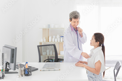 doctor talk with female patient about disease symptom  doctor use stethoscope listening to chest of patient  adult health check up in happiness hospital