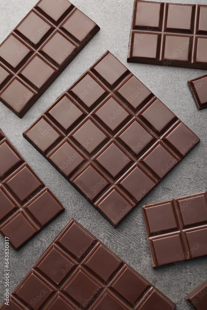 Delicious dark chocolate on grey table, flat lay Delicious dark chocolate on grey table, flat lay