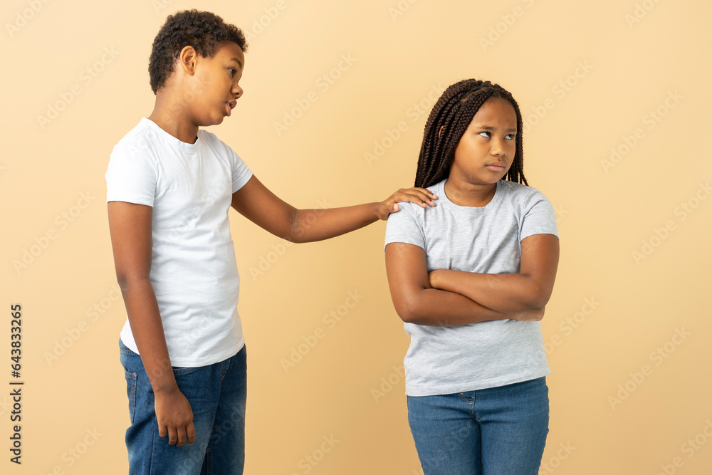 Attractive African American girl and boy, little brother apologizing to his little sister supporting - obrazy, fototapety, plakaty 