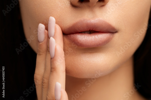 Unrecognizable young woman touching face with fingers