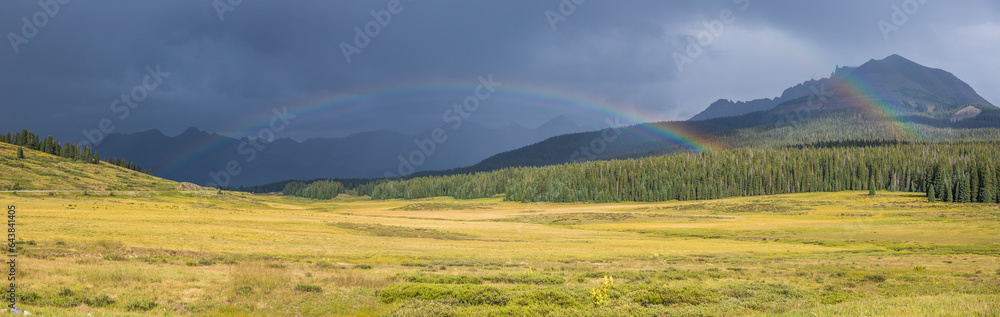 Rainbow panorama in the alpine mountain meadow