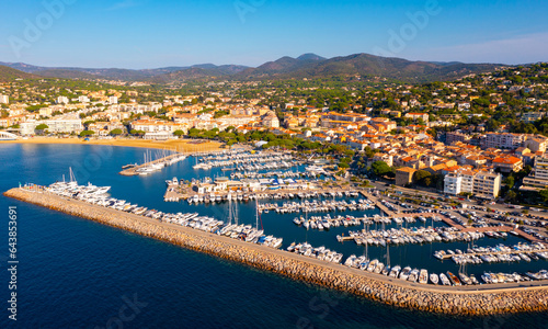 Summer aerial view of French coastal town of Sainte-Maxime on Mediterranean coast overlooking marina with moored pleasure yachts 