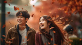 落ちてくる紅葉を見上げて幸せそうな日本人カップル