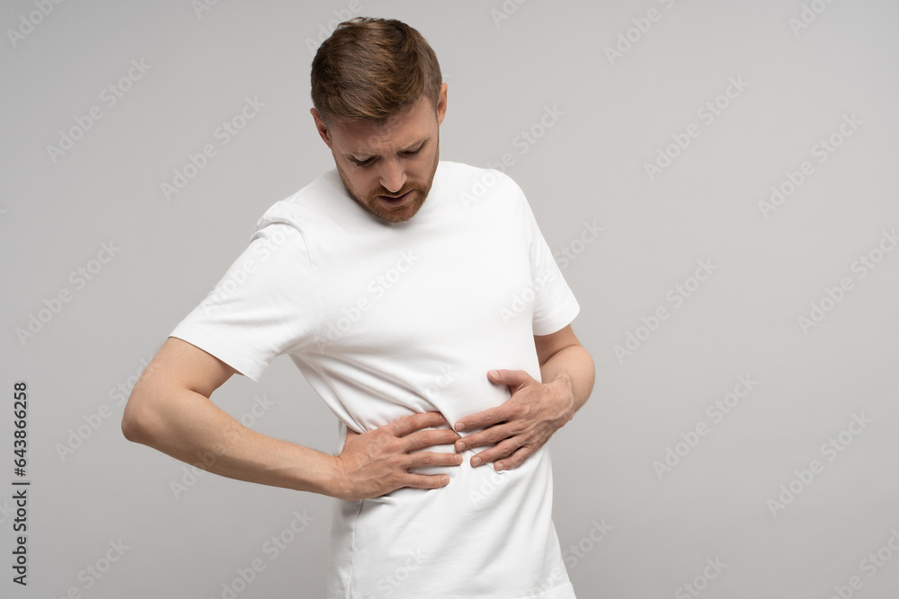 Ache in right side. Sick man suffering from under ribs
