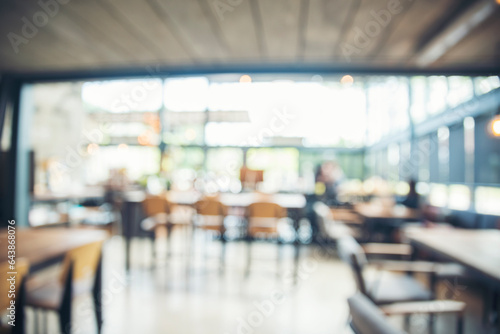 Blurred background cafe coffee shop restaurant in shopping mall with light bokeh business event retail store. Blurry background interior design bar table chair windows decorate indoor space display © aFotostock