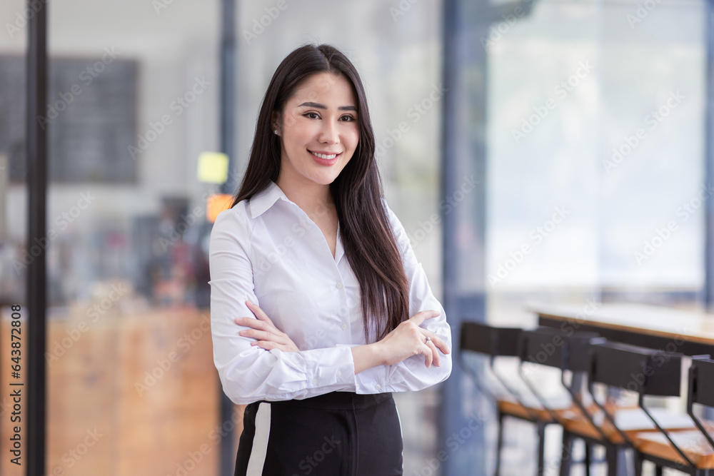 Portrait of successful business asian women arms crossed and smile dressed casually with happy and self-confident positive expression isolated over office background