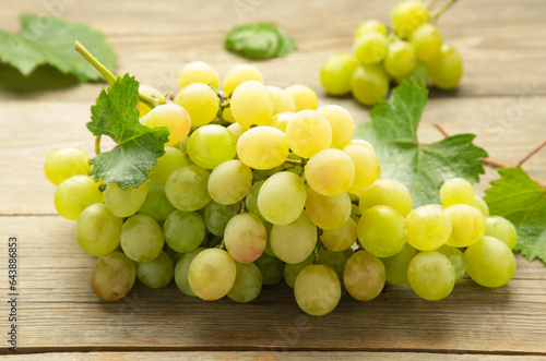 Shine Muscat Grape. Bunch of green grape on grey wooden background. Vertical photo