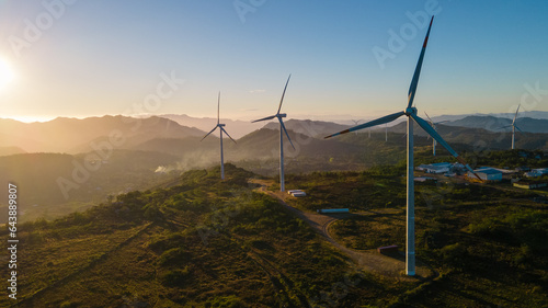 Beautiful sunrise over a park of wind turbines and with some fog