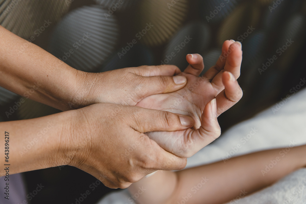 Process of hand massage. Wrist knuckle tendon stretching and acupressure for relaxation and healing in the spa for Asian woman healthcare Process of hand massage. Wrist knuckle tendon stretching and acupressure for relaxation and healing in the spa for Asian woman healthcare