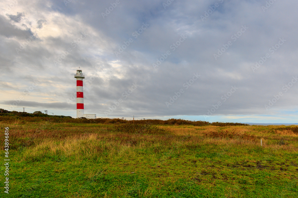 Coastal lighthouse with red and white stripes on Rishiri Island in Hokkaido