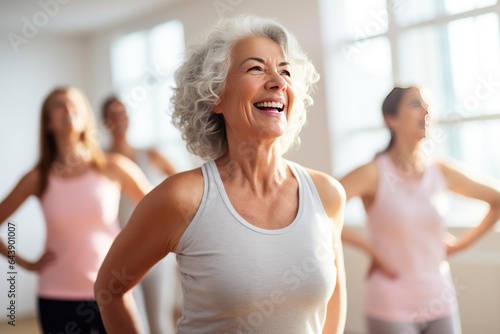 Middle-aged woman standing in a fitness studio, candidly expressing their active lifestyle through sport with friends.