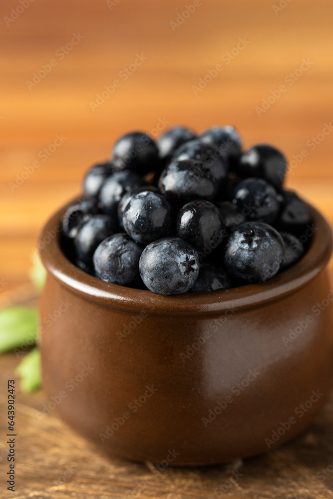 Rustic bowl with Blueberries fruit on wooden table. Copy space Rustic bowl with Blueberries fruit on wooden table. Copy space