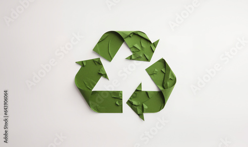 Green Recycle symbol made from green paper on white background