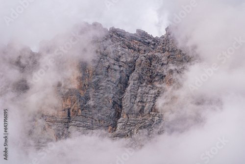 south side of mount Zugspitze partially covered with clouds moody