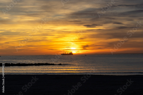 Sunset on the Zapillo beach in Almeria  Spain  ship in front of the Sun