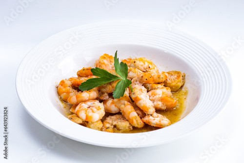 prawns with parsley with white plate