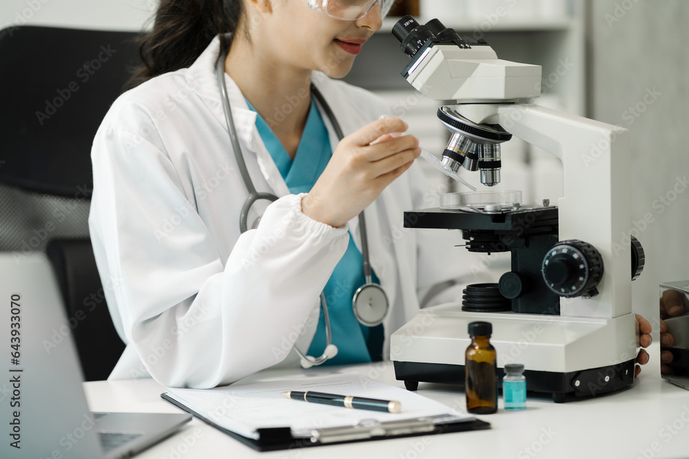 Female scientist researcher conducting an experiment working in the chemical laboratory. Female scientist researcher conducting an experiment working in the chemical laboratory.
