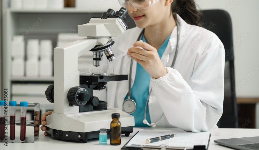 Female scientist researcher conducting an experiment working in the chemical laboratory. Female scientist researcher conducting an experiment working in the chemical laboratory.