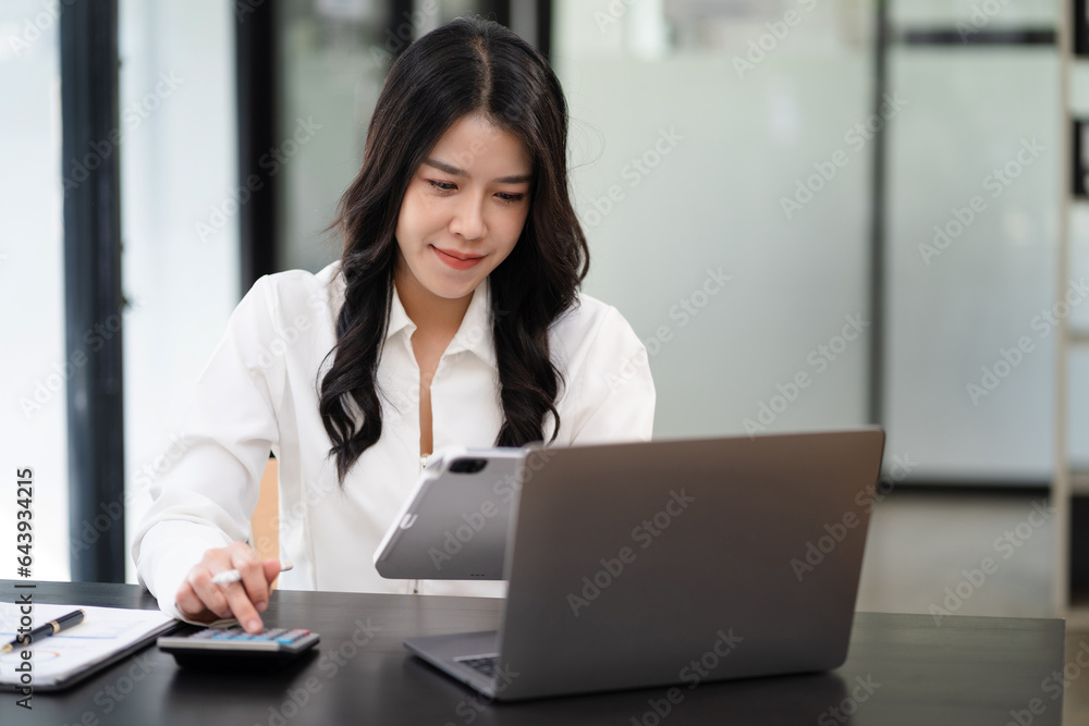 Women are using calculators to calculate office income. Women are using calculators to calculate office income.