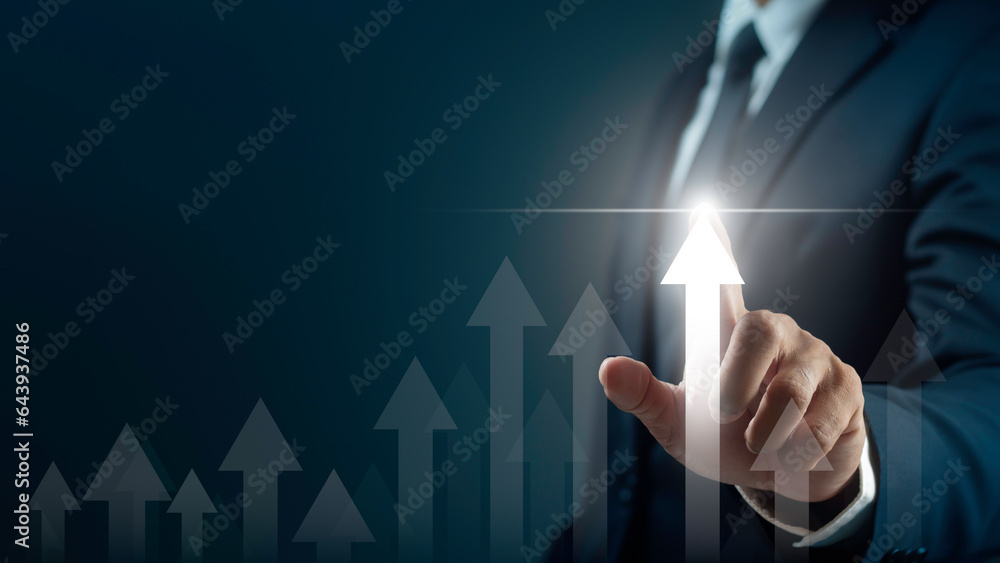 Businessman is pointing arrow graph corporate future growth plan. Business development to success motivation concept. Businessman is pointing arrow graph corporate future growth plan. Business development to success motivation concept.