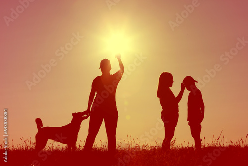 group of children playing in the sunset with dog