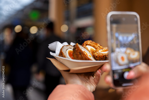 Traditional UK eggs with mobile phone taking picture.