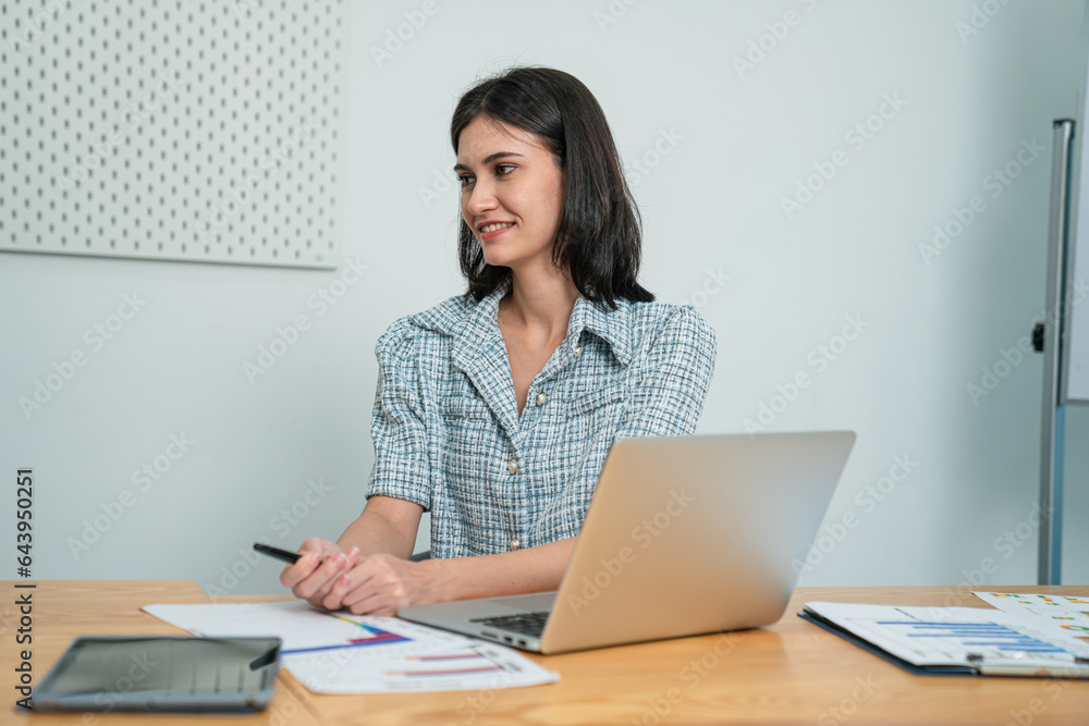 Successful businesswoman working with laptop at her office desk, Concept of business risk analysis and assessment Successful businesswoman working with laptop at her office desk, Concept of business risk analysis and assessment