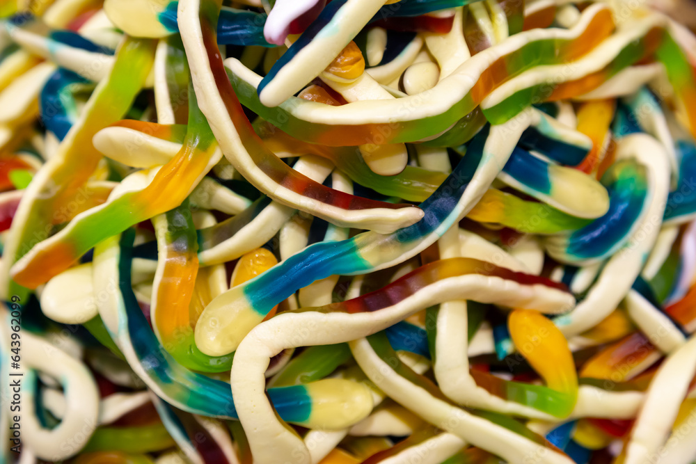 Fototapeta premium Colorful jelly candies in the form of worms, candy background.
