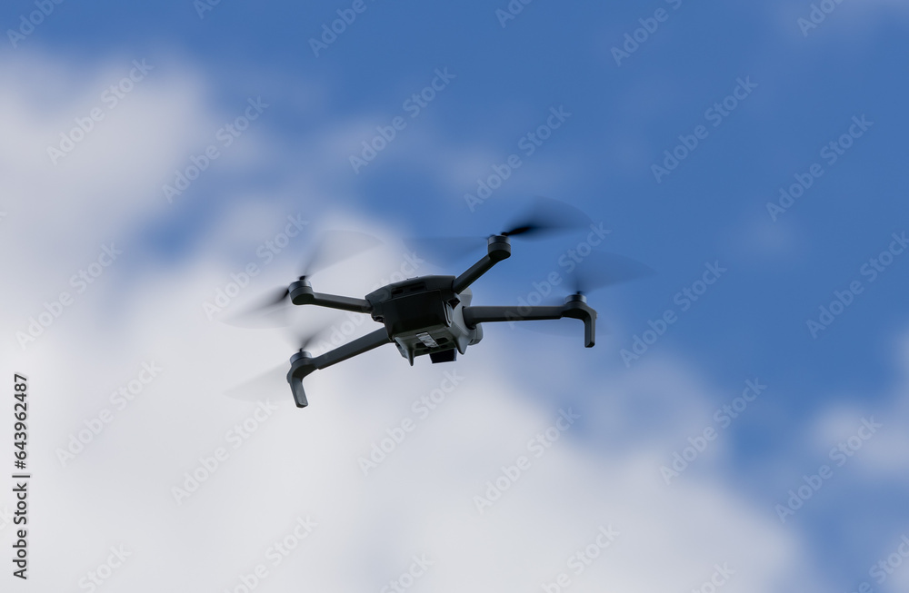 drone hovering in a bright blue sky. New technology in the aero photo shooting. drone hovering in a bright blue sky. New technology in the aero photo shooting.