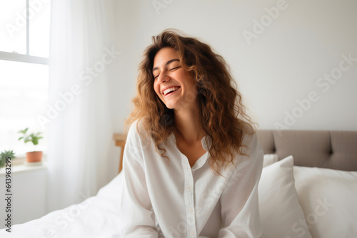 Young Woman Relaxing with Her Smartphone in Bed