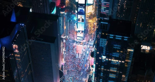 Helicopter Night Tour of New York City. Fly-By Over Glowing Times Square with Colorful Mock Up Advertising Billboards and Groups of Tourists Enjoying Manhattan Nightlife and Admiring the Landmark