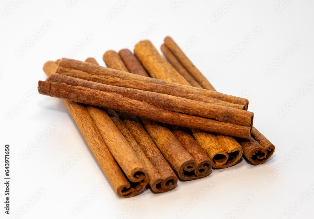Many cinnamon sticks on a white background