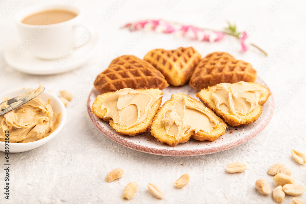 Homemade waffle with peanut butter on a gray concrete. side view, selective focus. Homemade waffle with peanut butter on a gray concrete. side view, selective focus.