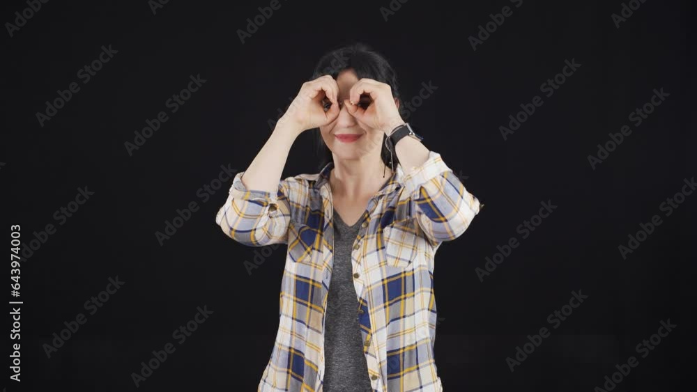Woman with binoculars looking away. Woman with binoculars looking away.
