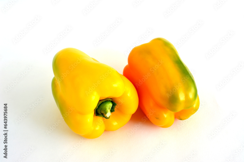 two yellow peppers isolated on the white background close up two yellow peppers isolated on the white background close up