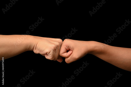 Friends giving fist bump to each other. Gesture of giving respect, showing unity, teamwork and friendship
