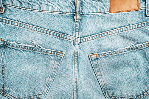 Back of light blue jeans close-up. Trendy casual wear.