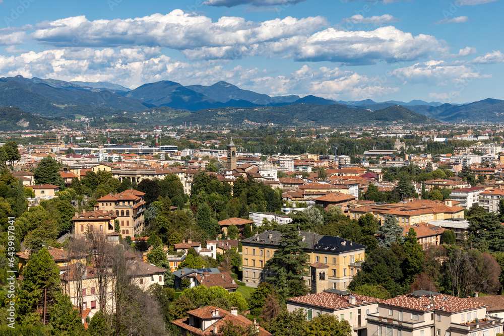 Downtown Bergamo, Italy, August 7, 2023; Panoramic view of buildings, mountains and cloudy sky, Cityspase